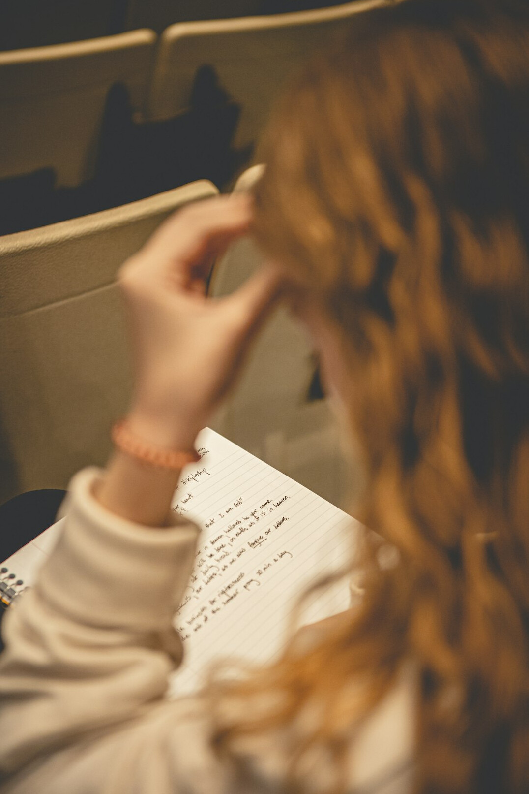 person writing notes on paper